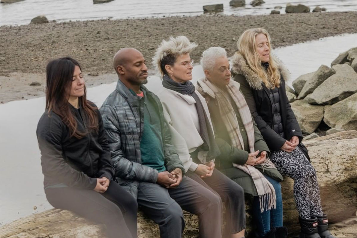five people sitting and meditating