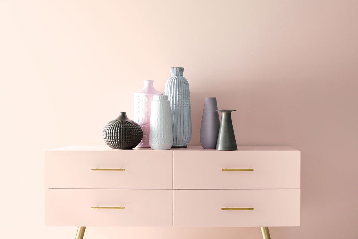 blush pink cabinet with vases on top