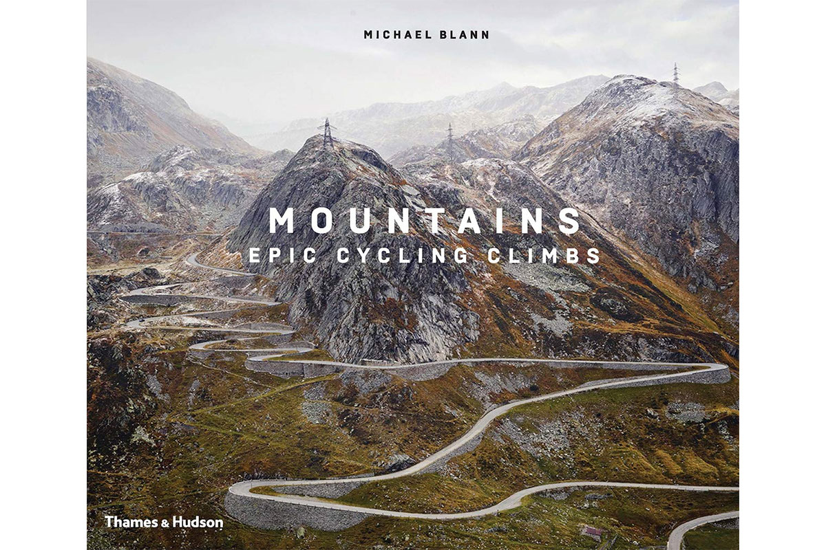 mountains epic cycling climbs book cover with large white mountains and meandering road