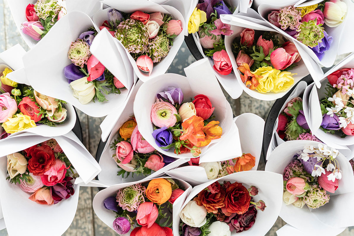 colorful flower bouquets wrapped in white paper