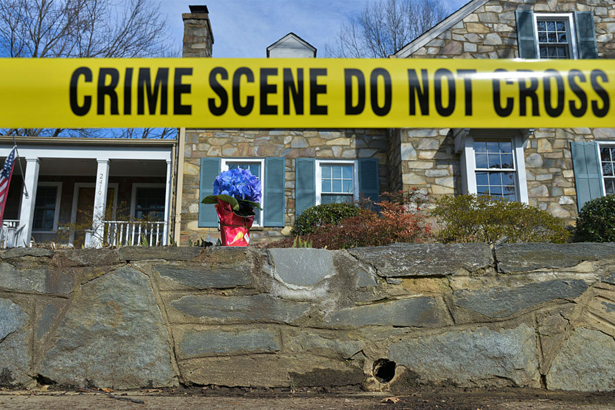 crime scene do not cross tape in front of stone house