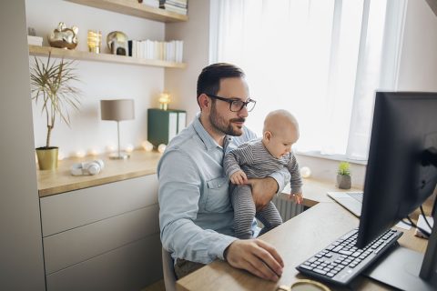 dad and baby looking at computer screen