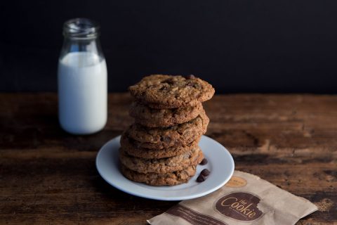 doubletree hilton chocolate chip cookies with milk in background