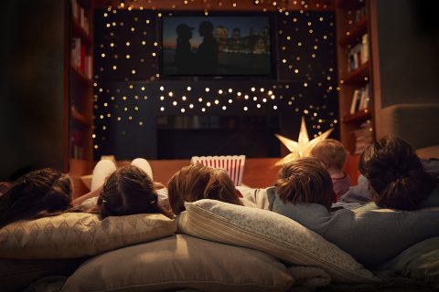 family laying down watching a movie