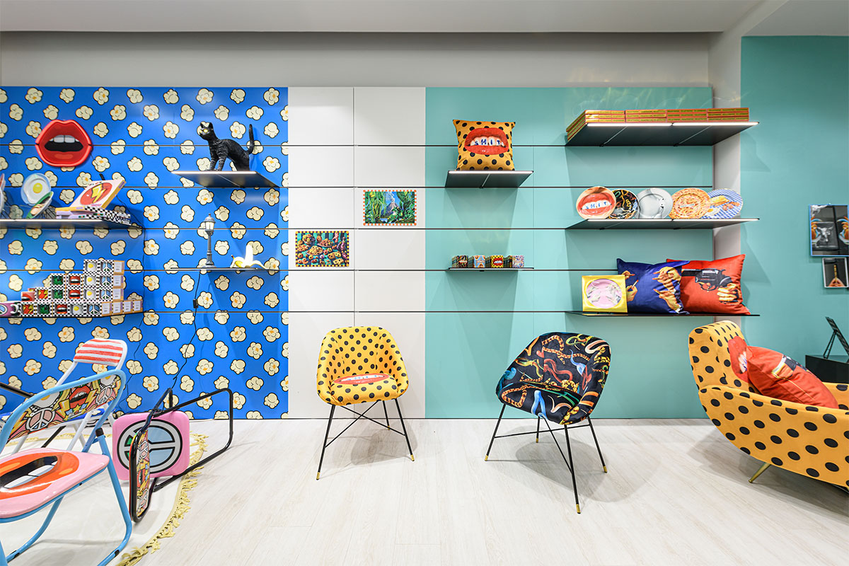colorful store showroom with yellow polka dots pattern, blue walls and furniture
