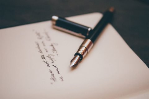 pen on top of handwritten letter
