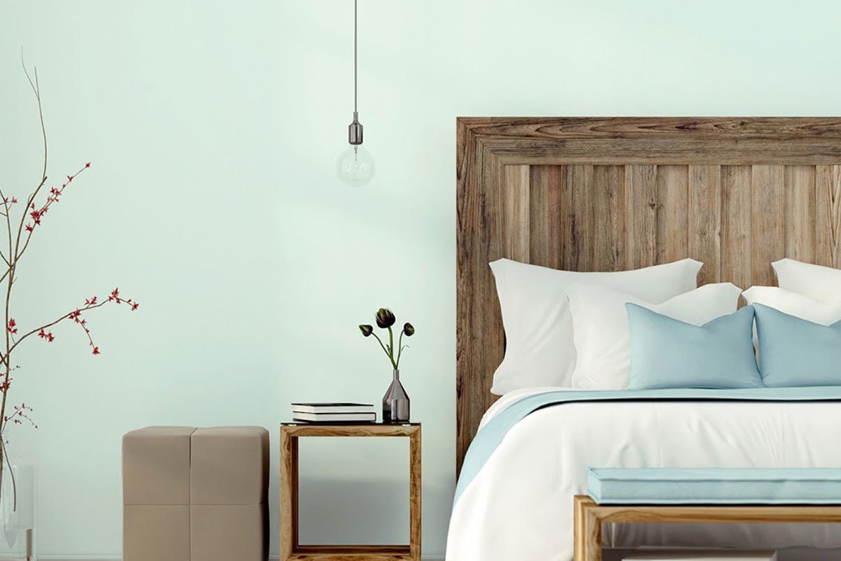 mint wall with wooden bed in front