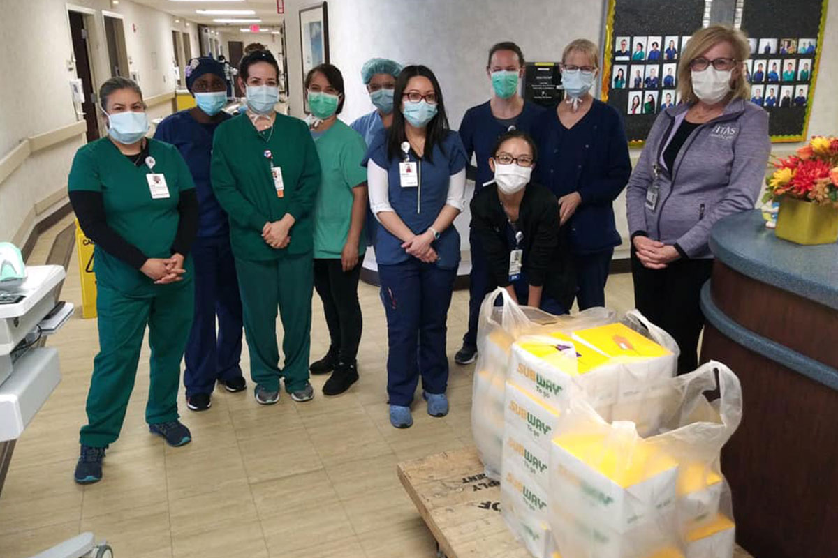 hospital staff with masks and subway sandwiches