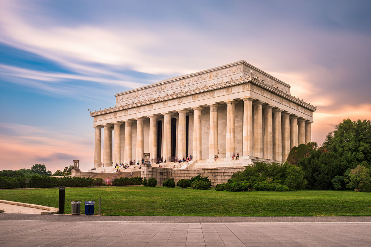 lincoln memorial with sunset behind and blue sky with white clouds