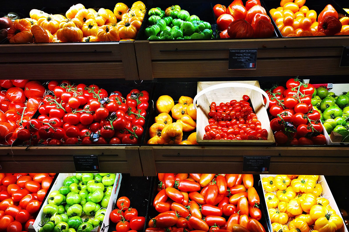 brightly colored produce peppers and tomatoes at grocery store