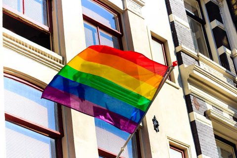 lgbt flag hanging outside of building