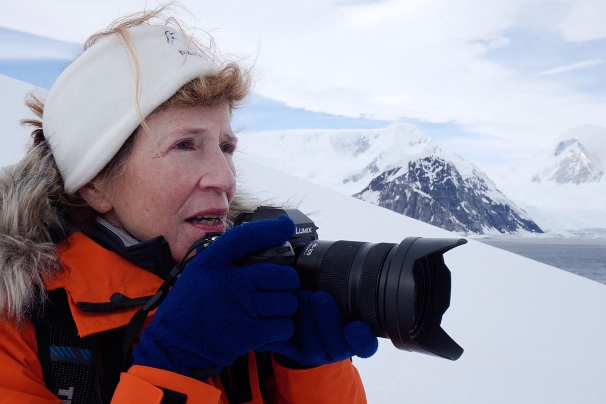 annie griffiths holding camera in Antarctica