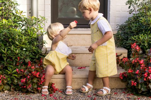 two young boys in yellow jumpsuits