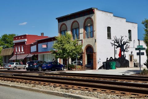 buildings behind train tracks