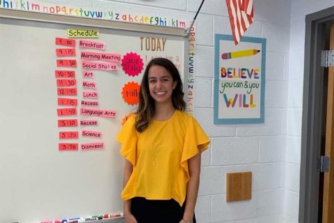 teacher from beech tree elementary standing in front of white board