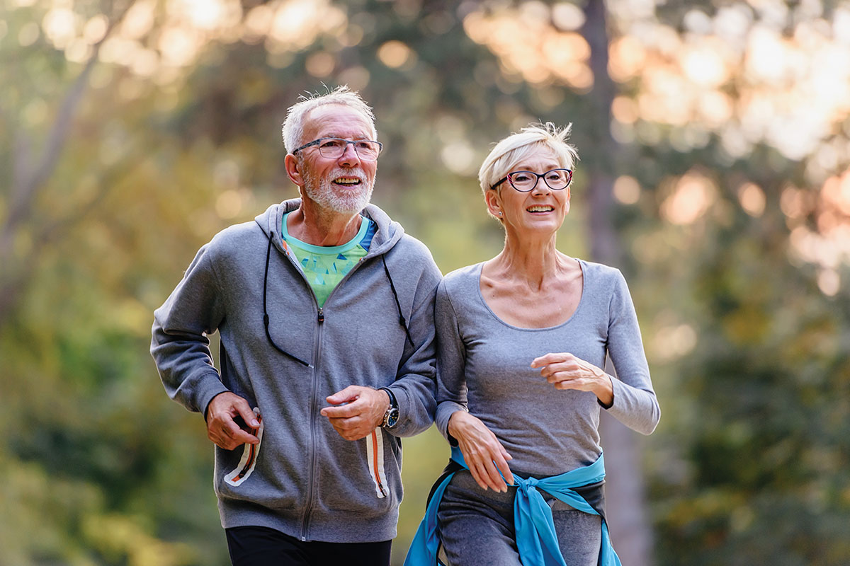elderly couple jogging together