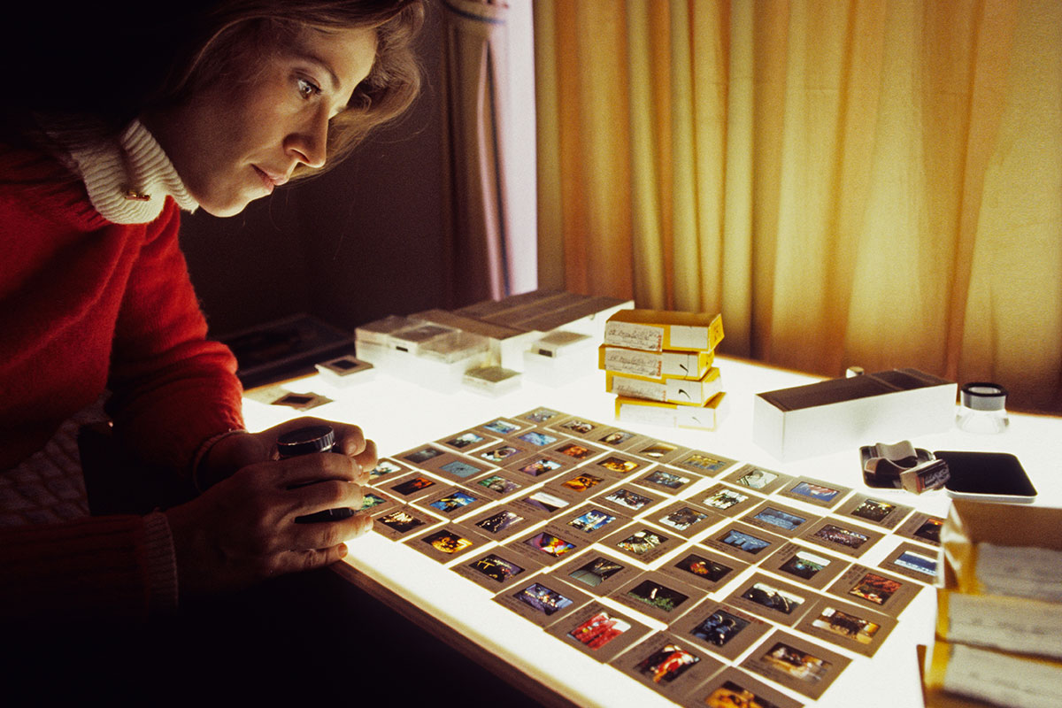 annie griffiths editing photos in a dark room studio