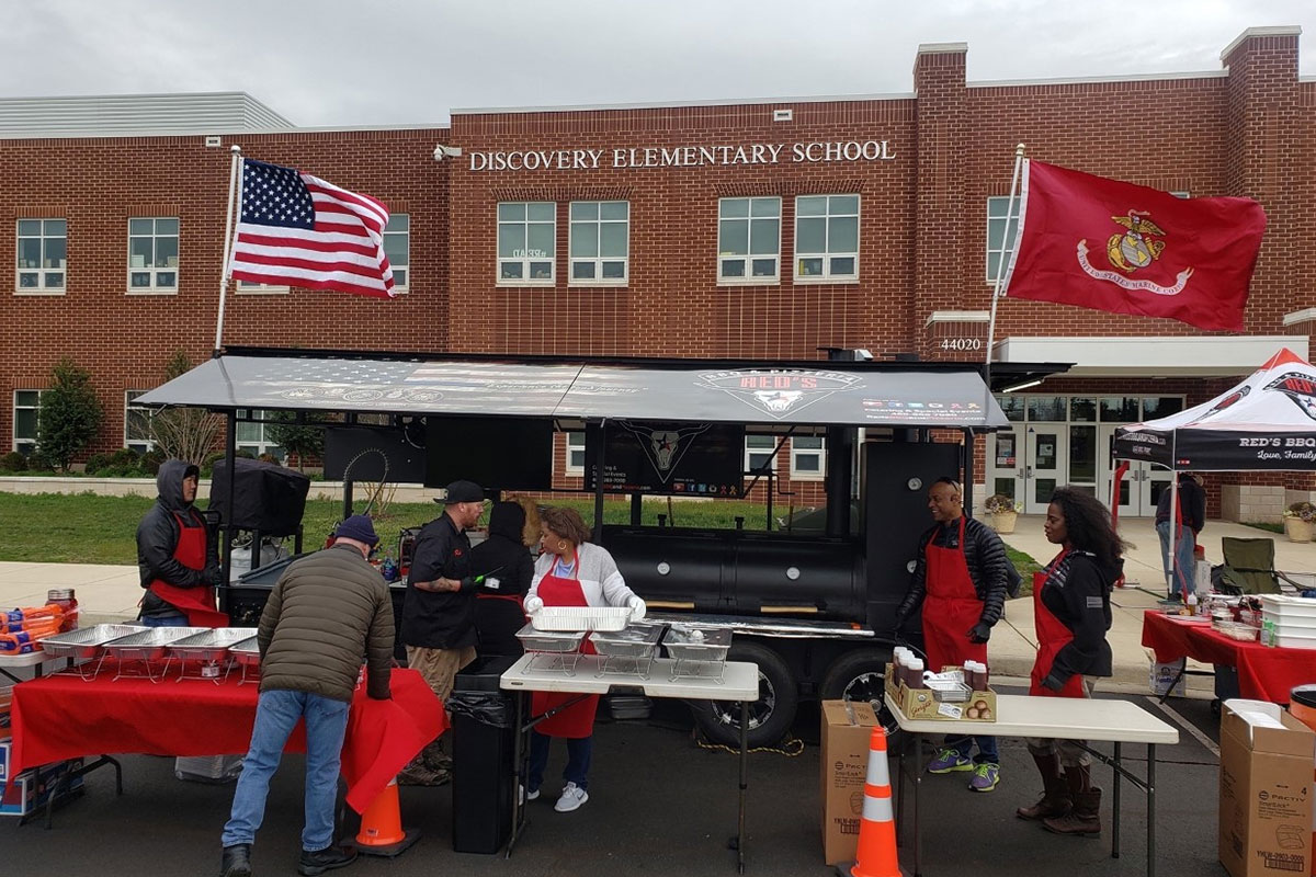 elementary school with food workers out front