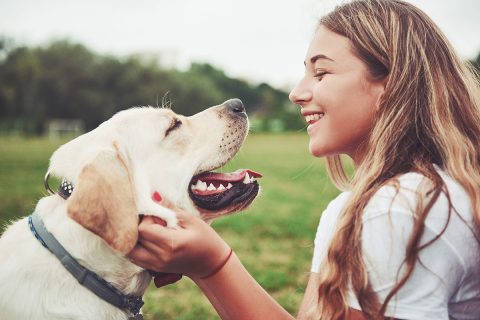 young girl petting dog