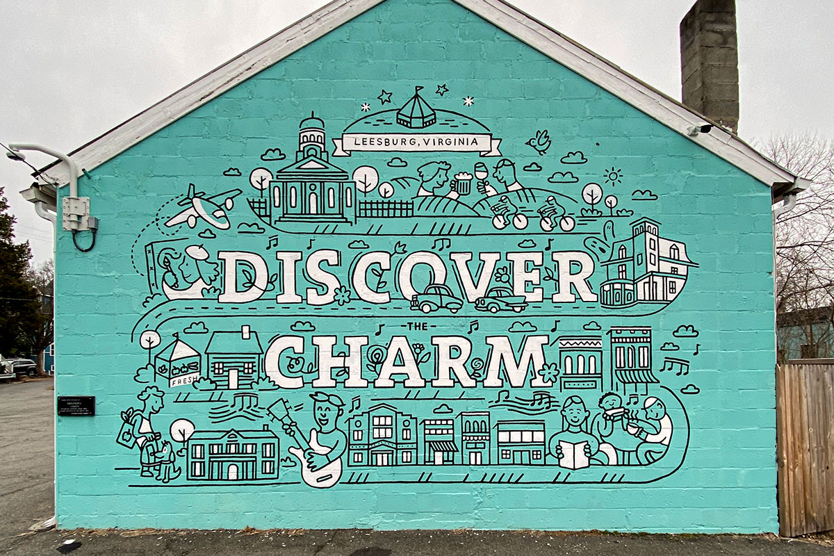 painting mural with teal background that says discover charm in leesburg virginia