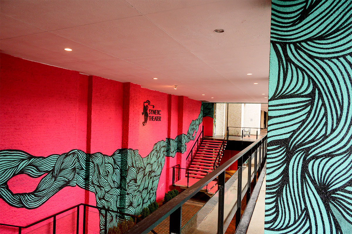 bright pink and teal mural synetic theater
