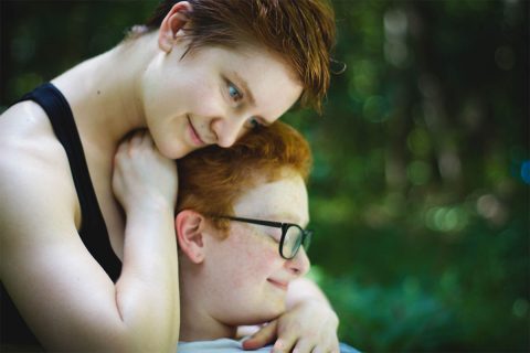 professional cuddler indigo dawn cuddling a redheaded child