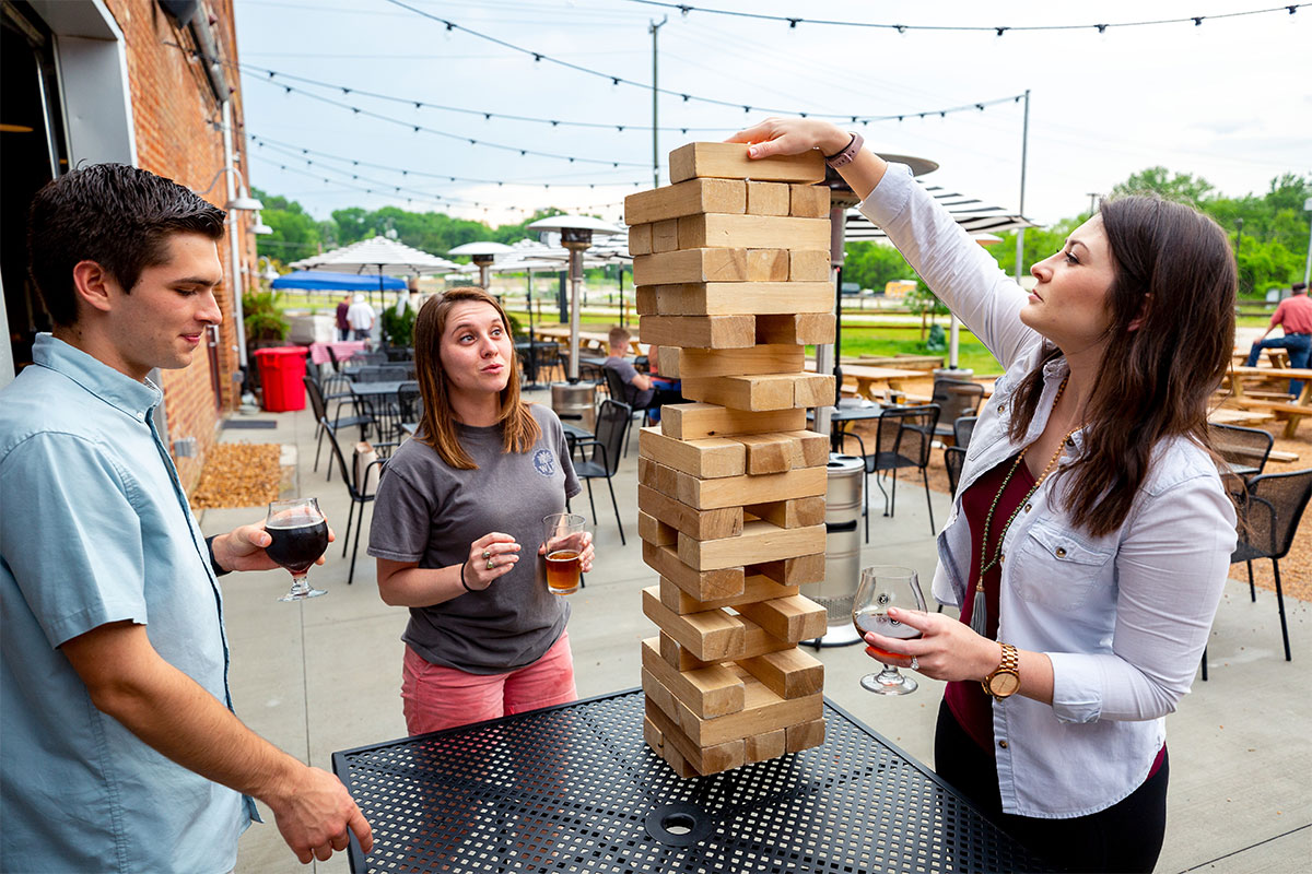 group of college students playing jenga at brewery