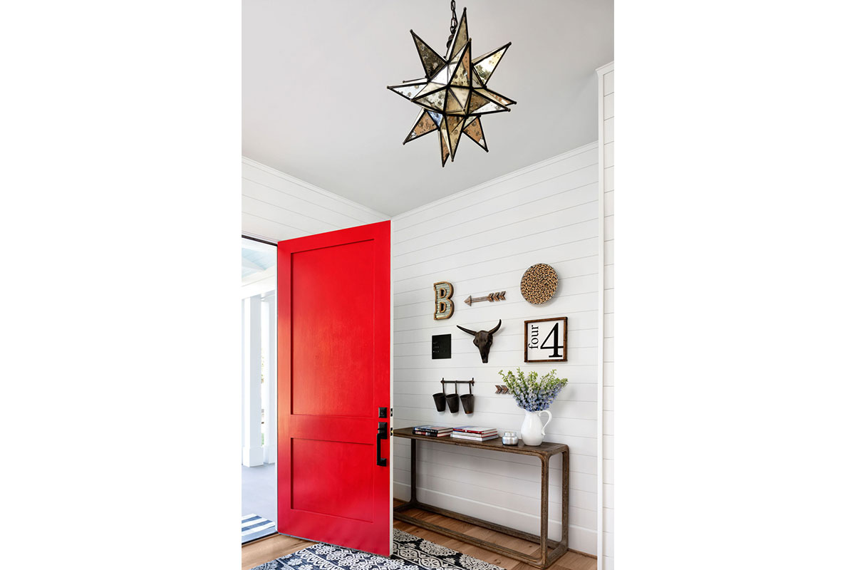 white foyer with moravian star and bright red front door