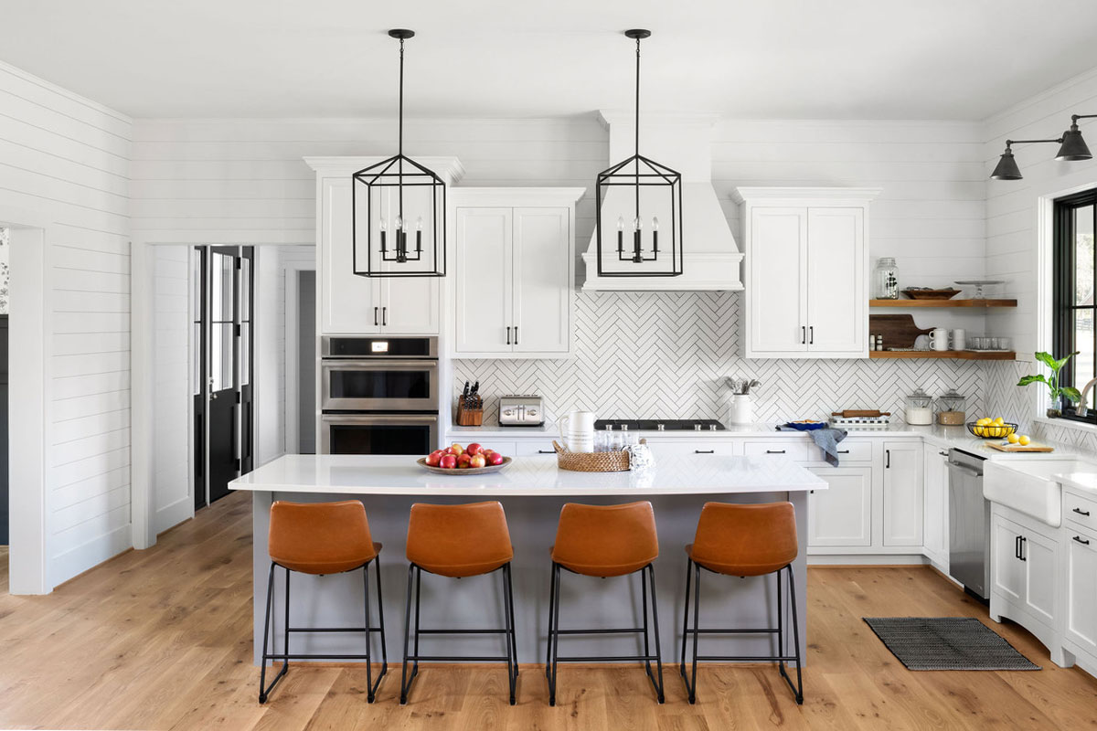 modern farmhouse kitchen with leather barstools, black lighting accests and white cabinets and countertops