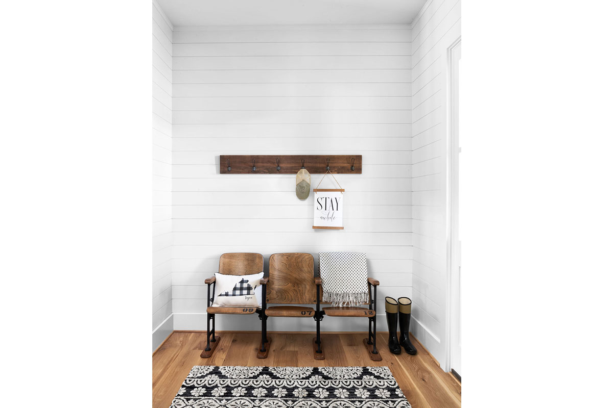 white walls with antique wooden lecture hall seats with sign and patterned rug
