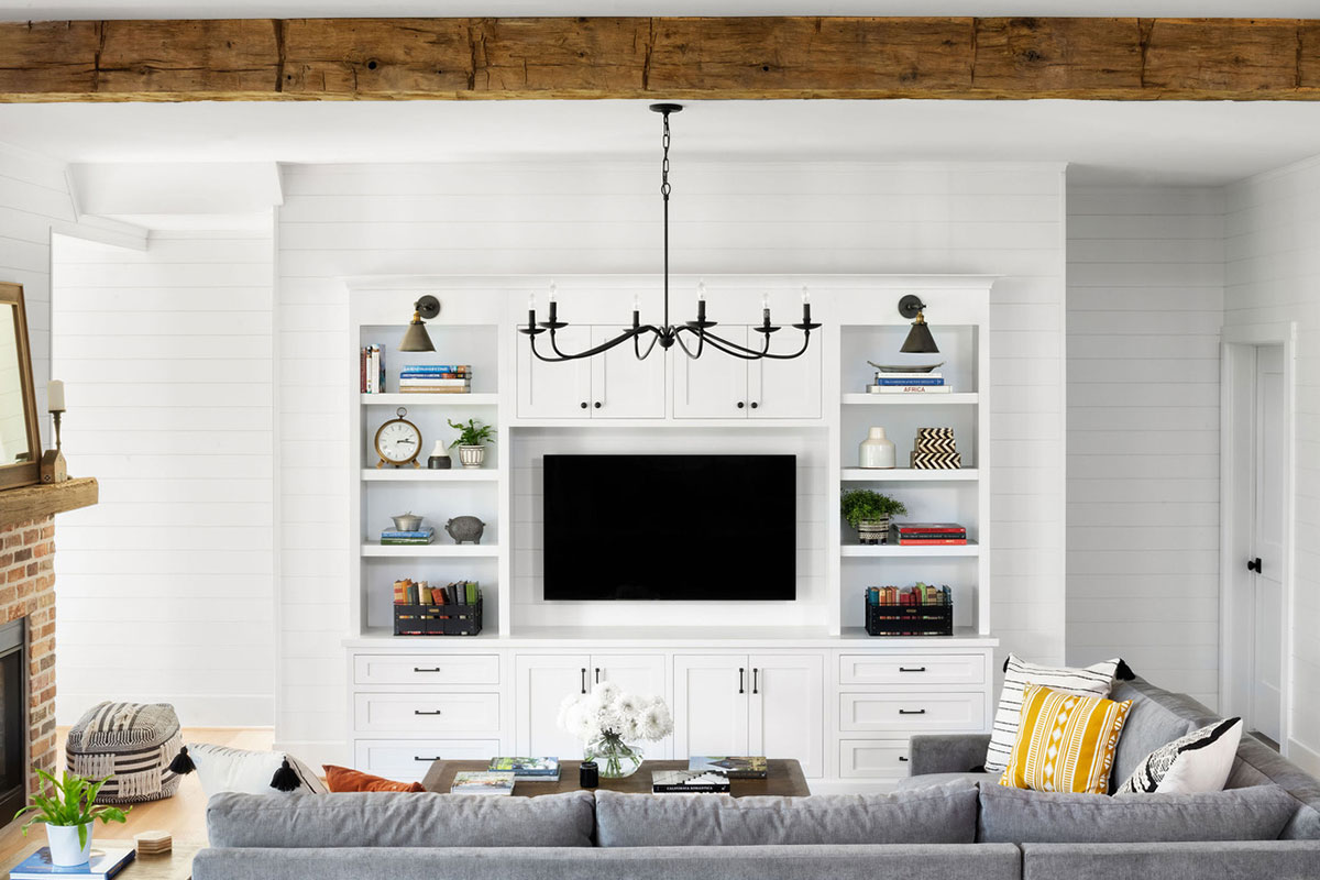 white cabinets in modern farmhouse with flat screen television and yellow accent pillow