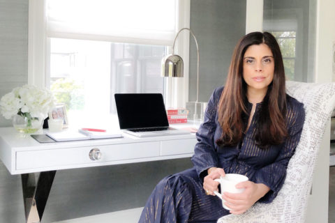 woman in pajamas at white desk