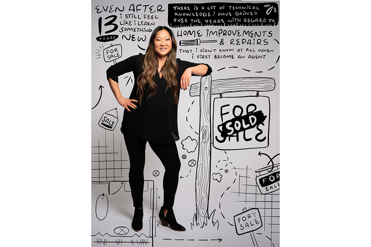 woman realtor in black outfit in front of doodles