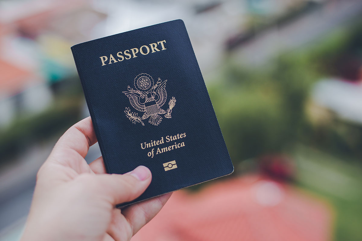 person holding dark blue us passport
