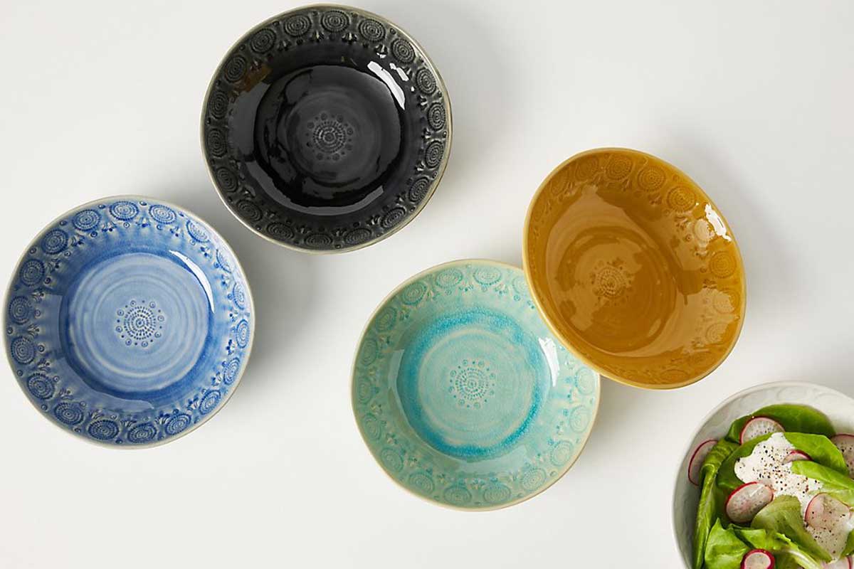 ceramic bowls blue, green, yellow and black with salad