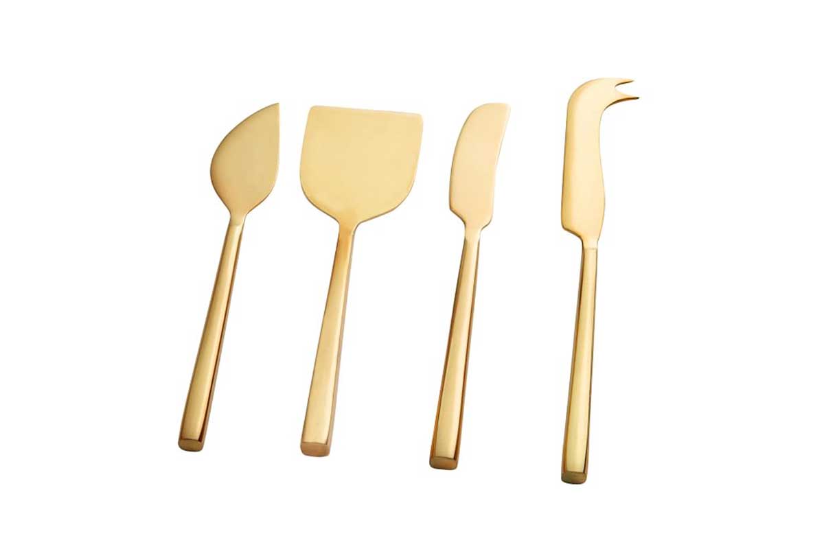 four gold cheese knives