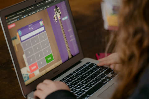 child on laptop using a calculator