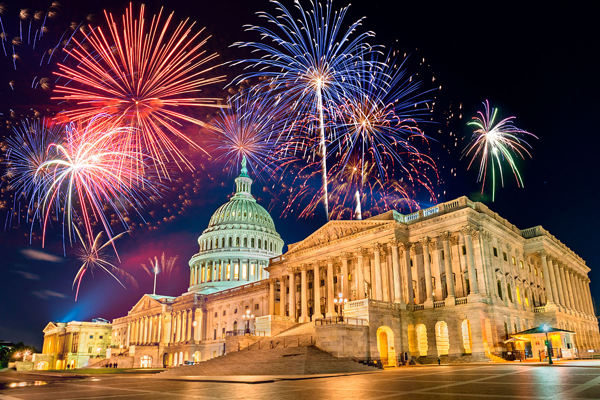 red white and blue fireworks over the capital building