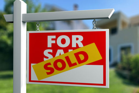 for sale sign in front of house