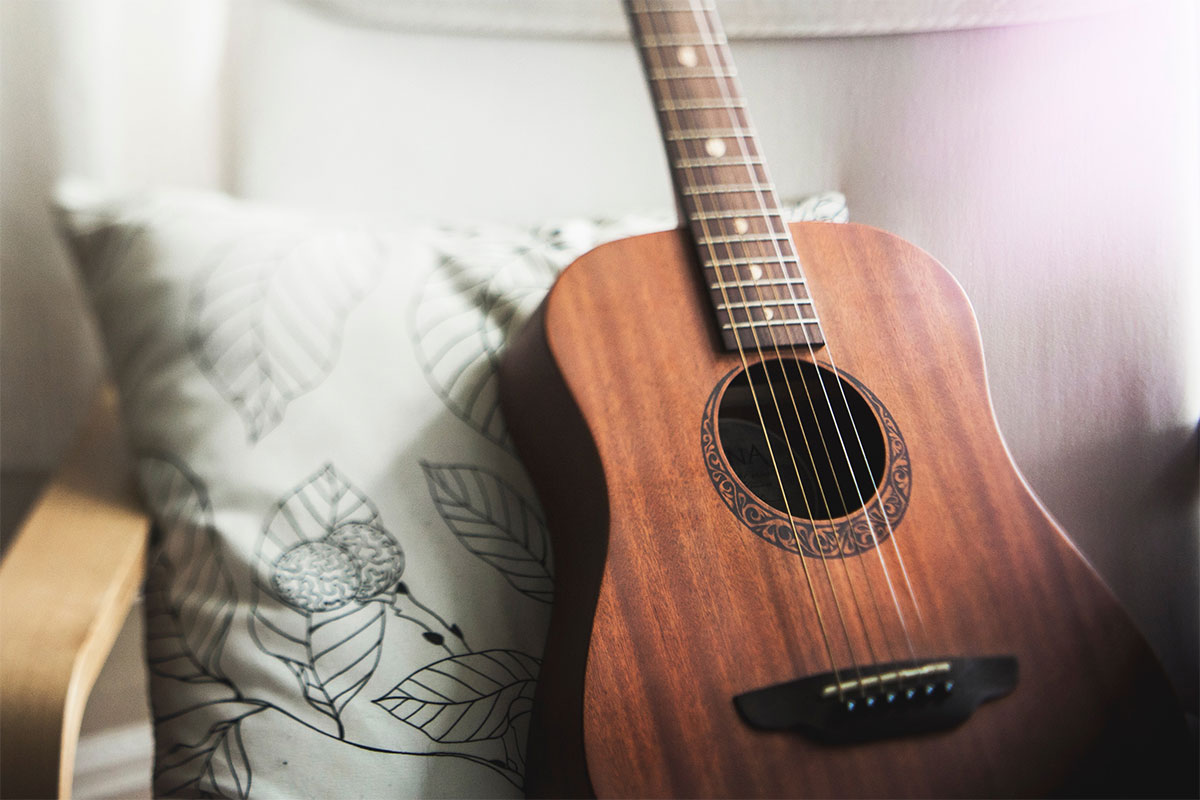 guitar resting on pillow