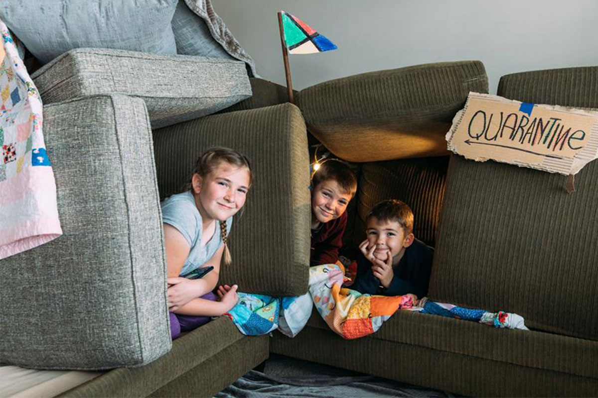 kids playing in fort built out of couch cushions