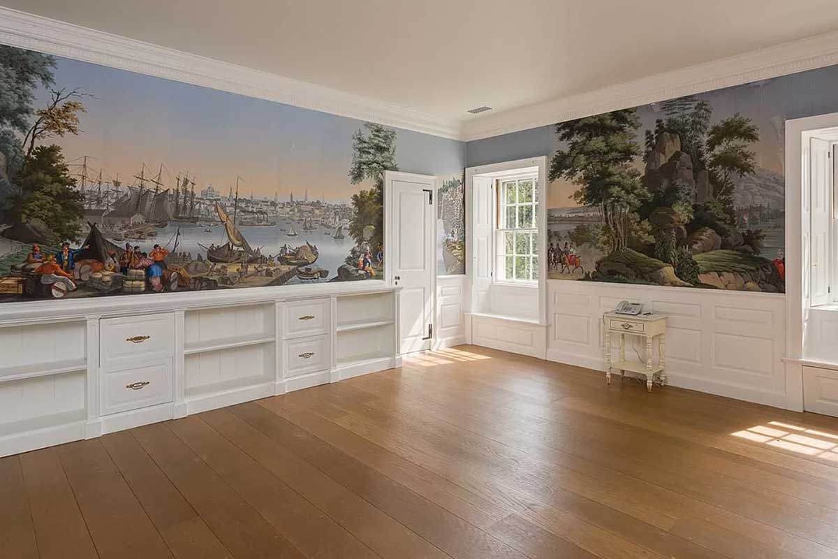 large room with painted mural on walls