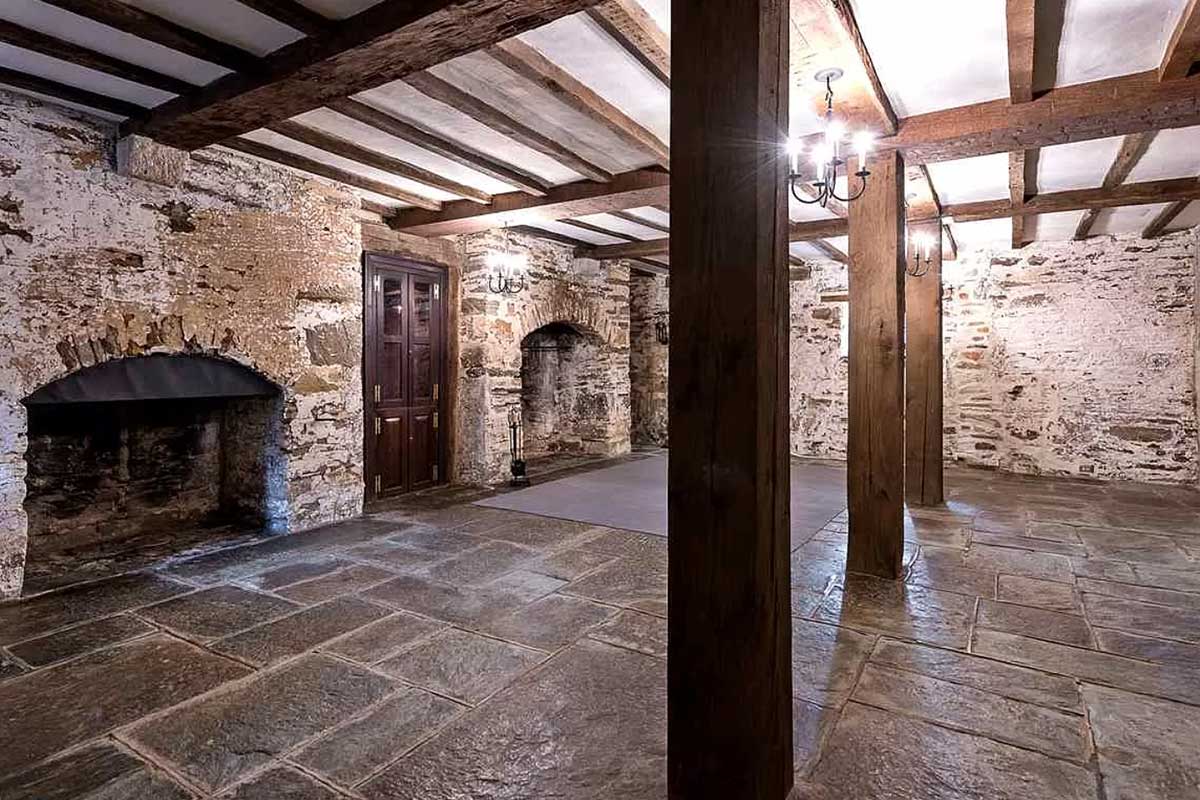 basement with stone flooring and walls
