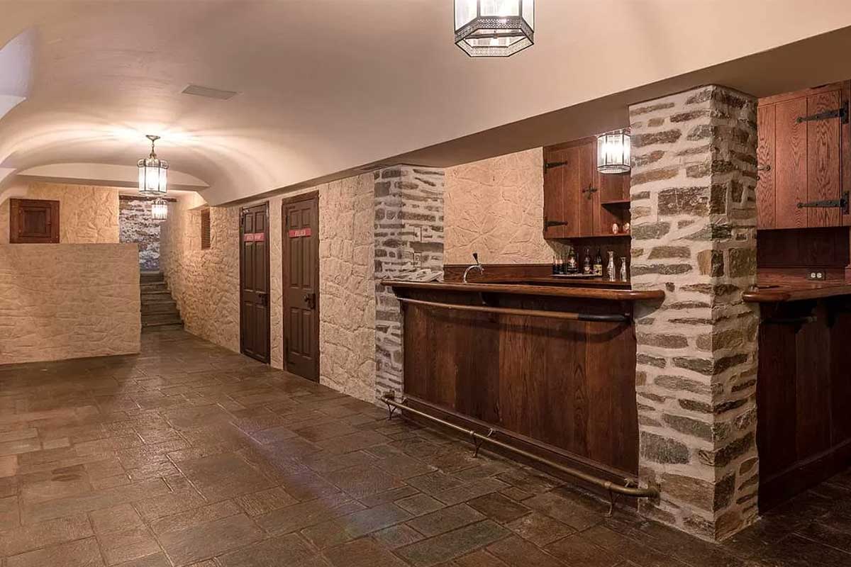 basement with bar and stone walls