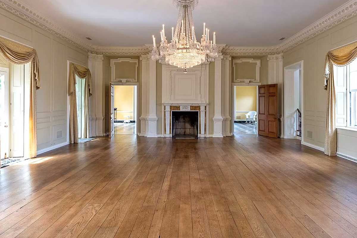 large living room with hardwood floors and glass chandelier