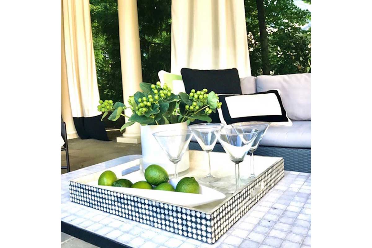 outdoor space with martini glasses and limes and couch and curtains