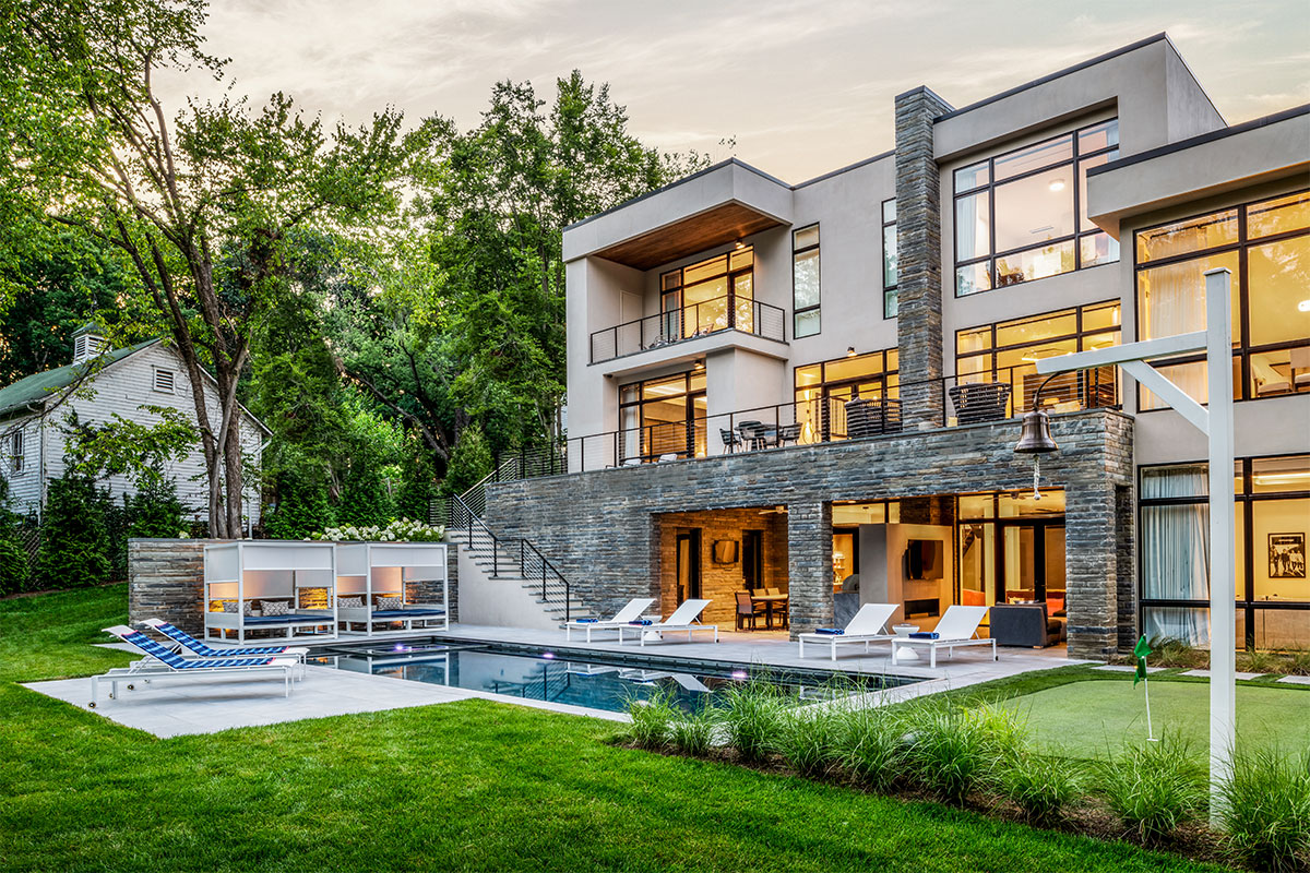 modern home with green backyard and pool