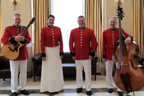 four people in red and white holding instruments