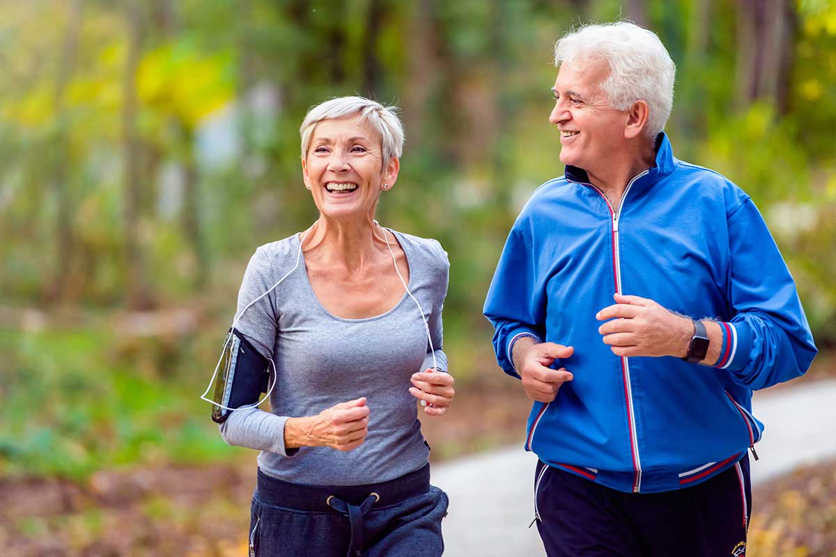 two people seniors running outside with grey long sleeve shirt and blue jacket