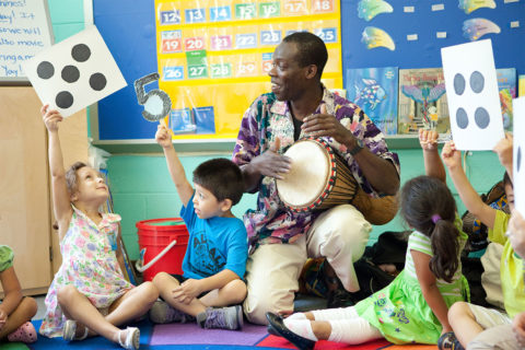 man playing drums for kids